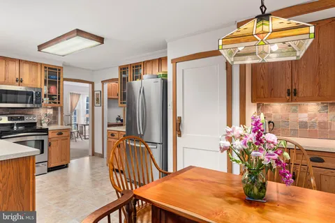 a kitchen with stainless steel appliances kitchen island granite countertop a refrigerator a stove top oven a sink and dishwasher