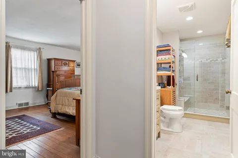 a view of a bedroom with closet and mirror