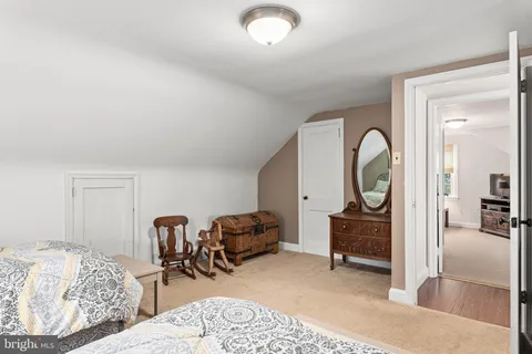 a bedroom with a bed a lamp and a window