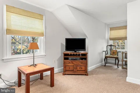a bathroom with a toilet and a shower curtain