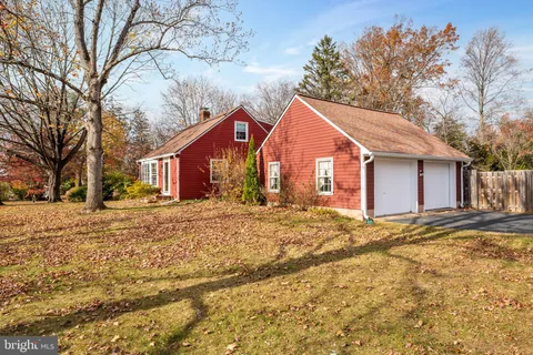 a view of a house with a yard covered in snow