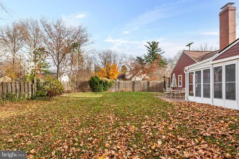 a front view of a house with patio and garden