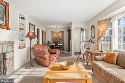 a living room with furniture fireplace and a large window