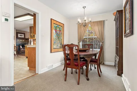 a view of a dining room with furniture and chandelier