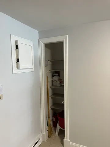 a view of a hallway with closet and a white door