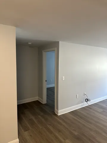 an empty room with wooden floor