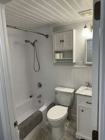 a bathroom with a toilet sink and shower