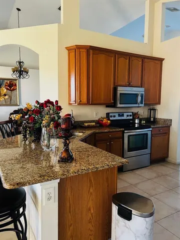 a kitchen with a sink appliances and cabinets