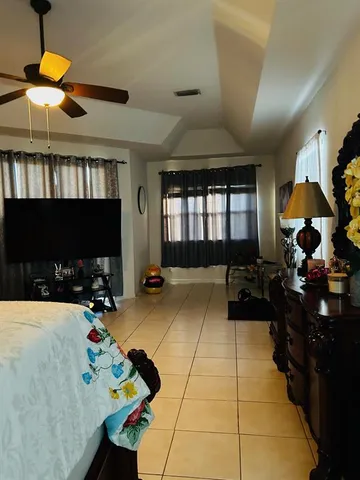 a living room with patio furniture and a fireplace