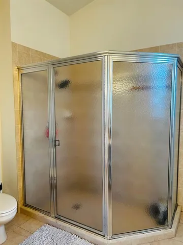 a bathroom with a glass shower door