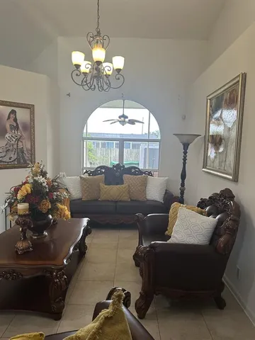 a living room with furniture and a chandelier