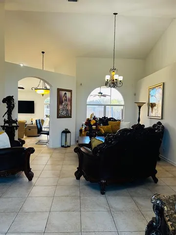 a living room with furniture a chandelier and a couch