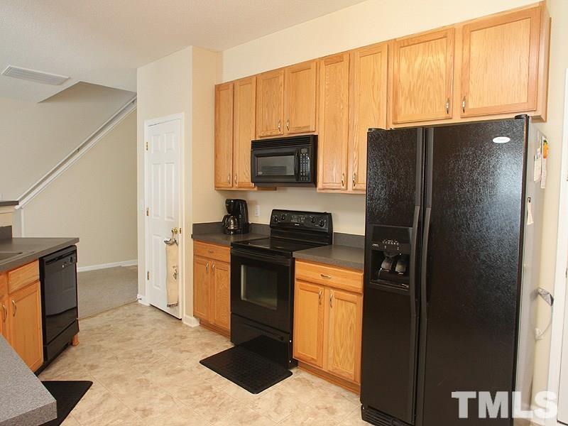 4453 Cardinal Grove Boulevard Raleigh, NC 27616 - Photo 2 of 6 a kitchen with granite countertop a refrigerator stove and microwave