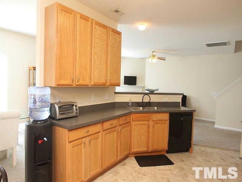 4453 Cardinal Grove Boulevard Raleigh, NC 27616 - Photo 3 of 6 a kitchen with a sink and cabinets