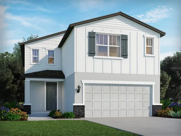 a front view of a house with a yard and trees