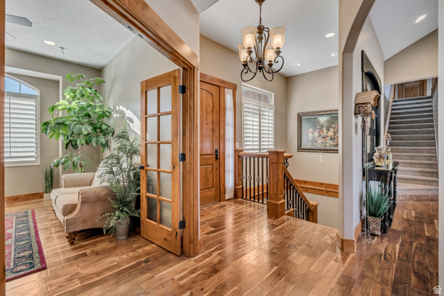 896 West 675 South Mapleton, UT 84664 - Photo 7 of 77 Foyer entrance with stairway, wood finished floors, recessed lighting, and a chandelier