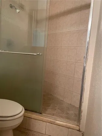 a bathroom with a shower and a toilet