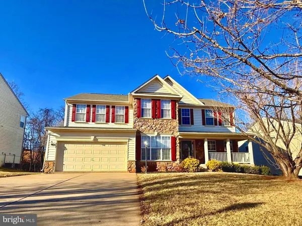 a front view of residential houses with yard