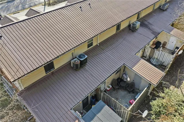 a balcony with wooden floor stairs and furniture