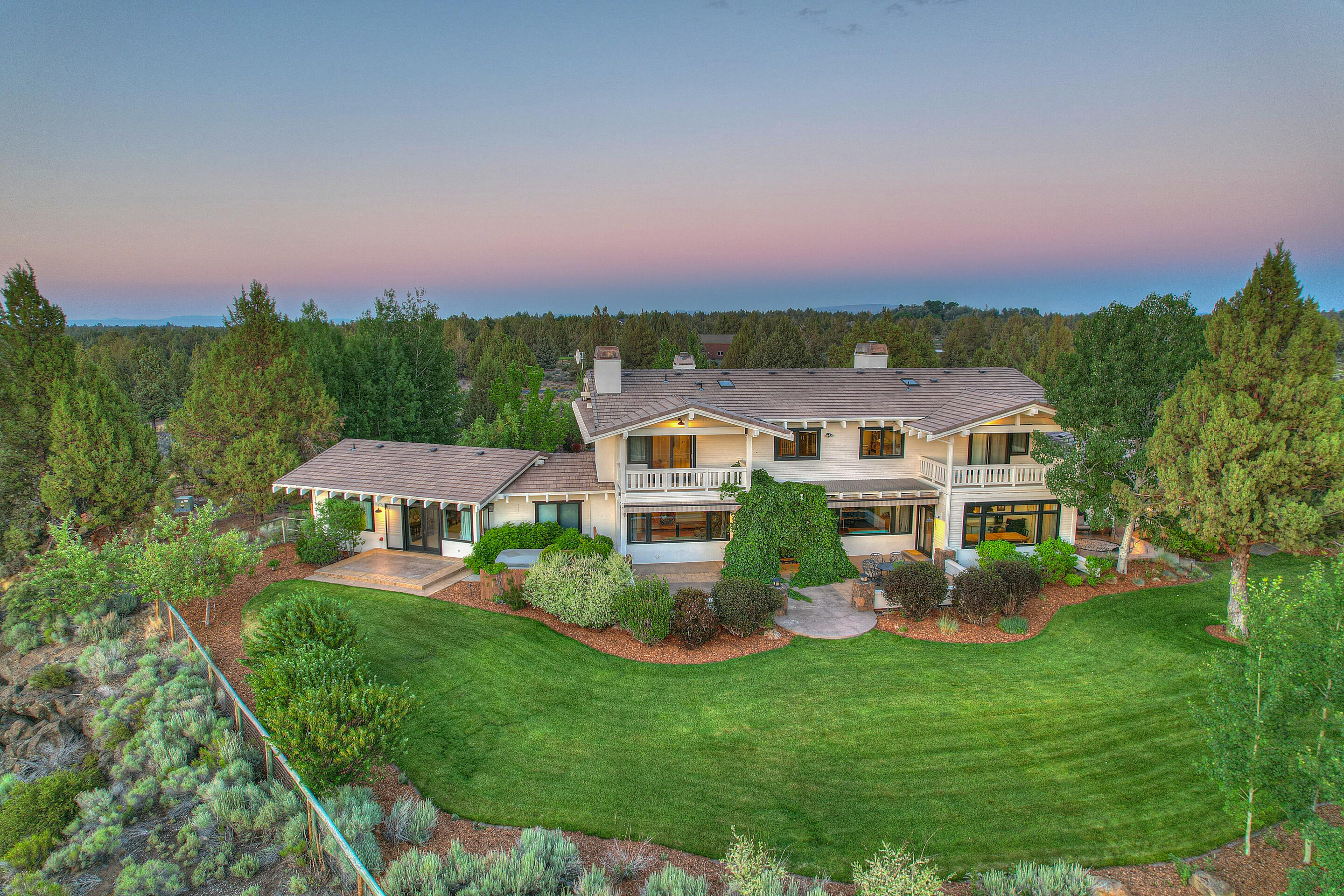 61415 Gosney Road Bend, OR 97702 - Photo 4 of 47 a front view of a house with a garden and plants