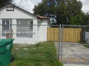 a backyard of a house with wooden fence