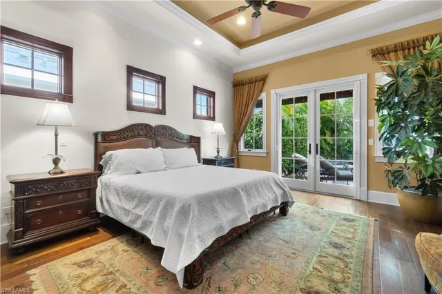 a spacious bedroom with a large bed a flat screen tv and a couch