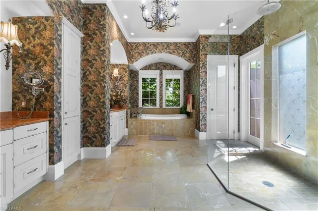 a spacious en suite bathroom with a double vanity sink and mirror