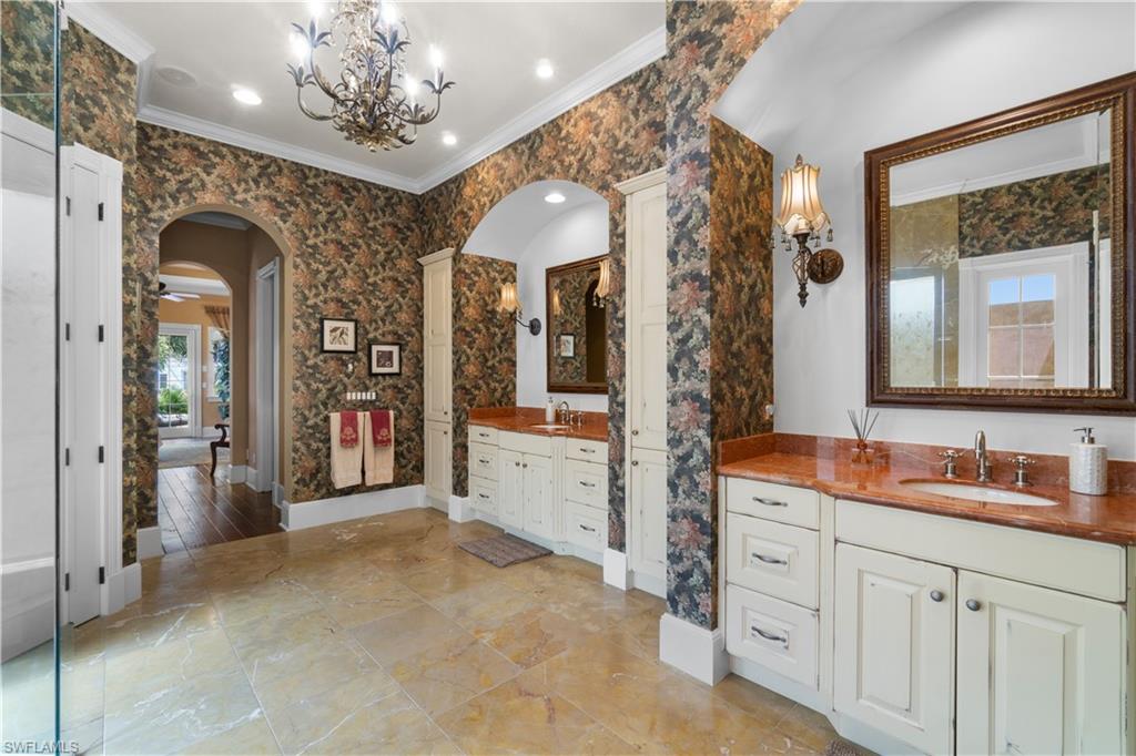 611 18th Avenue South Naples, FL 34102 - Photo 16 of 32 a spacious en suite bathroom with a double vanity sink and mirror