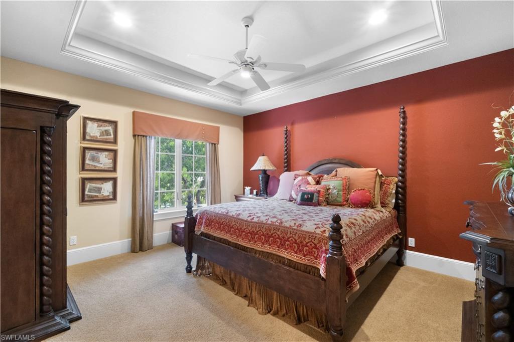 611 18th Avenue South Naples, FL 34102 - Photo 18 of 32 a bedroom with a bed lamp and a large window