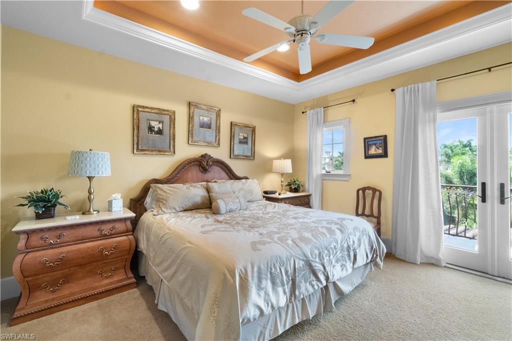 611 18th Avenue South Naples, FL 34102 - Photo 20 of 32 a bedroom with a bed and a chandelier