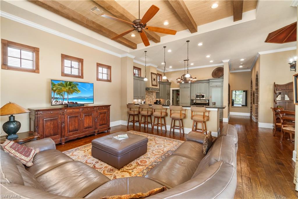 611 18th Avenue South Naples, FL 34102 - Photo 2 of 32 a living room with furniture and a flat screen tv