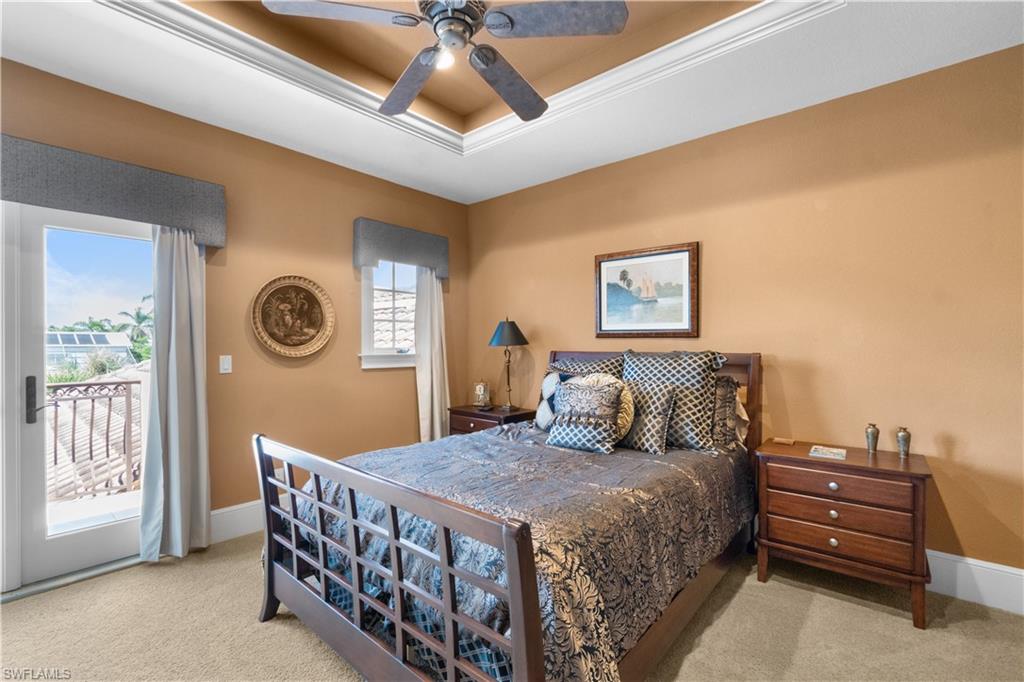 611 18th Avenue South Naples, FL 34102 - Photo 21 of 32 a bed room with a bed and a chandelier