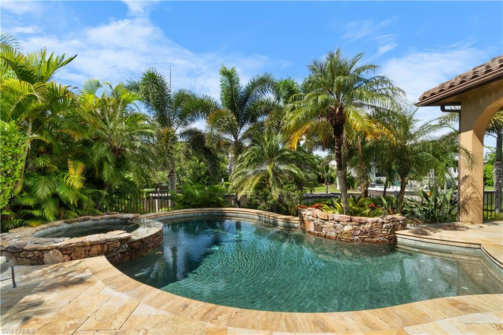 611 18th Avenue South Naples, FL 34102 - Photo 26 of 32 a view of a swimming pool with a yard