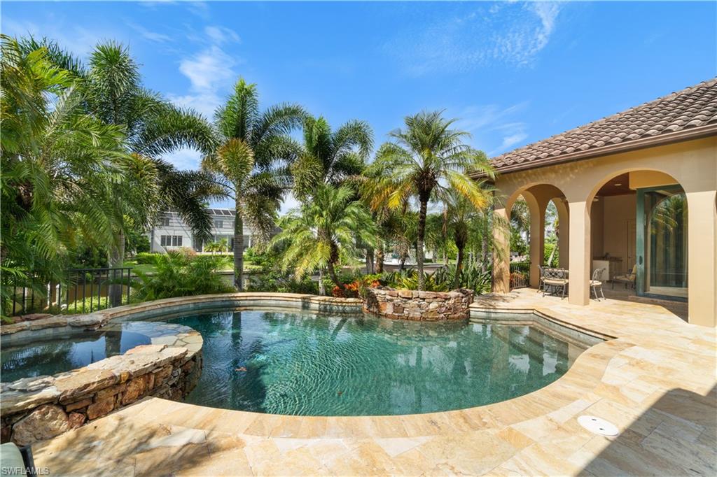 611 18th Avenue South Naples, FL 34102 - Photo 27 of 32 a view of a swimming pool with a patio