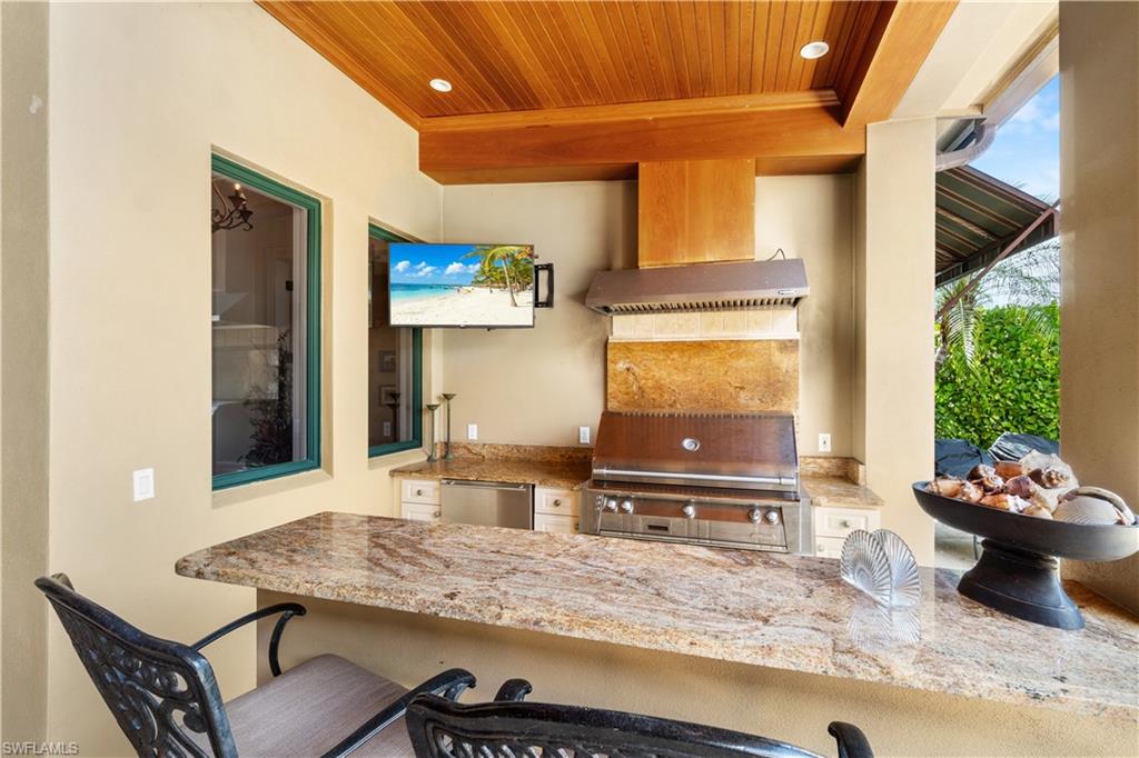 611 18th Avenue South Naples, FL 34102 - Photo 30 of 32 a kitchen with a table and chairs in it
