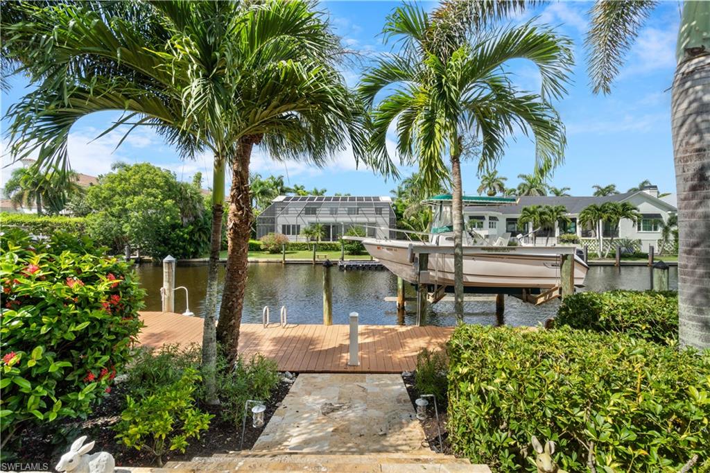 611 18th Avenue South Naples, FL 34102 - Photo 31 of 32 a view of a lake with a garden