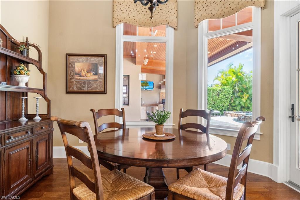 611 18th Avenue South Naples, FL 34102 - Photo 5 of 32 a view of a dining room with furniture window and wooden floor