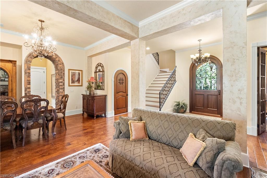 611 18th Avenue South Naples, FL 34102 - Photo 9 of 32 a living room with furniture a dining table and a chandelier