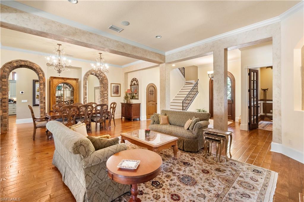 611 18th Avenue South Naples, FL 34102 - Photo 10 of 32 a living room with furniture a rug and wooden floor