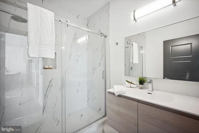 a bathroom with a shower and a sink