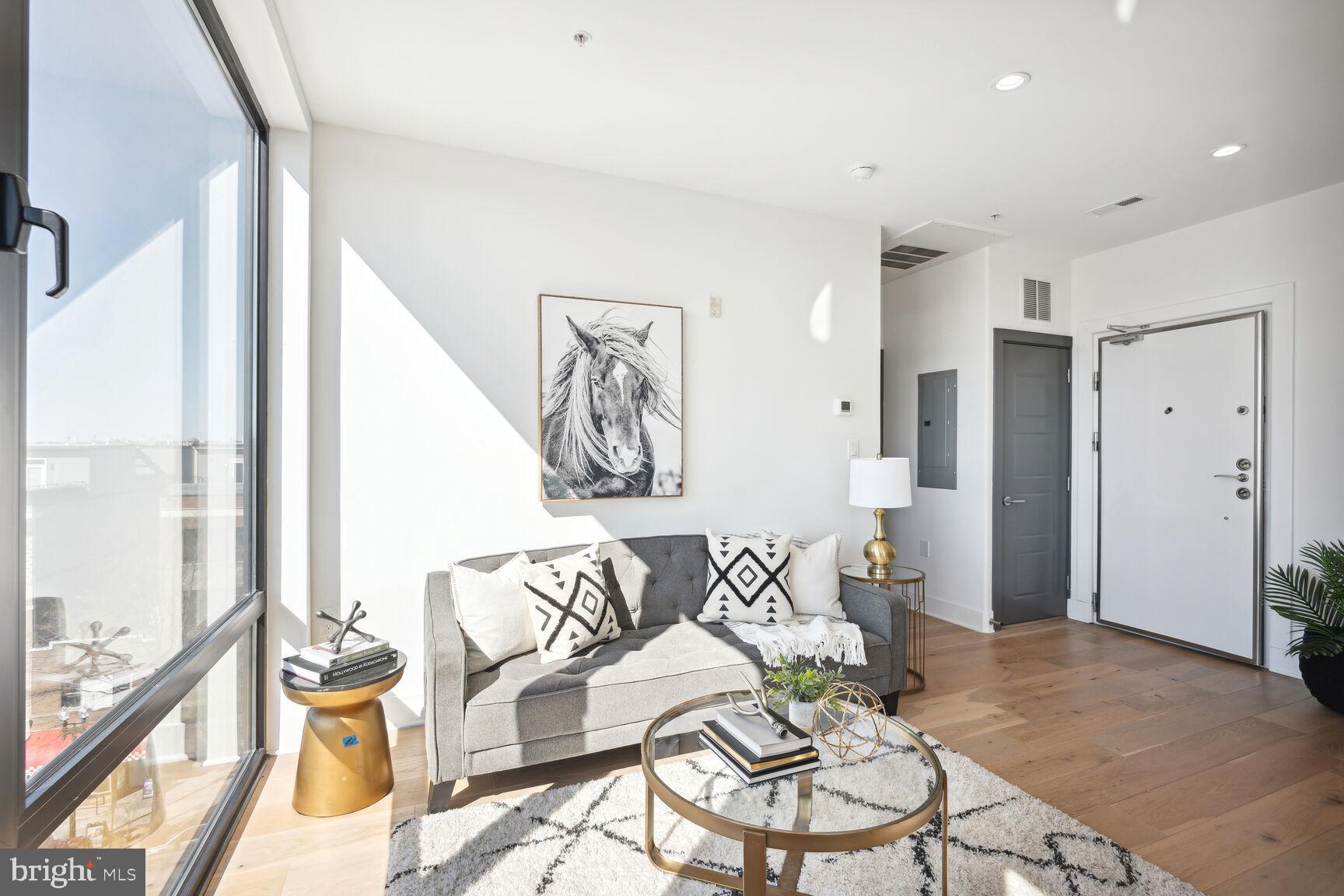 3619 Georgia Avenue Northwest, Unit 405 Washington, DC 20010 - Photo 2 of 16 a living room with furniture and a large window