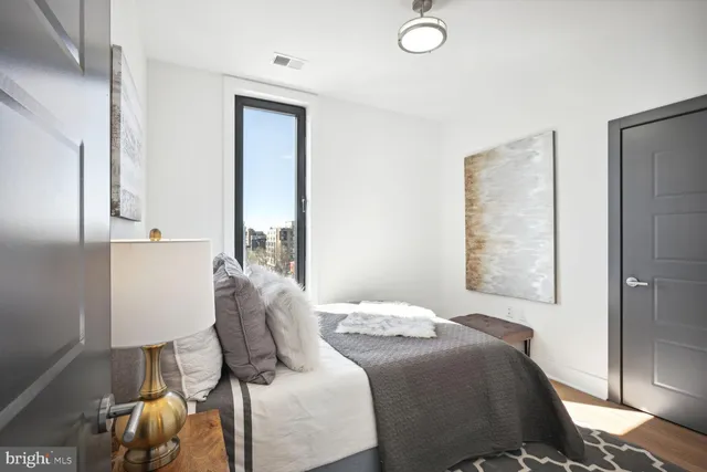 a bedroom with a bed and a window