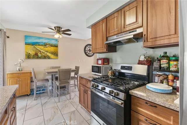 a kitchen with stainless steel appliances granite countertop a stove and a sink