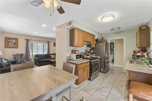 a kitchen with stainless steel appliances granite countertop a stove refrigerator and cabinets