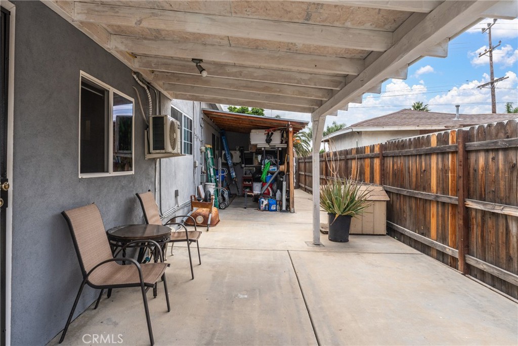 276 East Merrill Avenue Rialto, CA 92376 - Photo 17 of 35 a view of a patio with table and chairs and potted plants with wooden floor