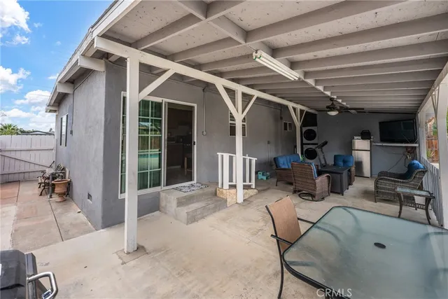 a building outdoor space with patio furniture and potted plants