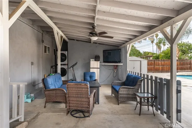 a living room with furniture a ceiling fan and a rug