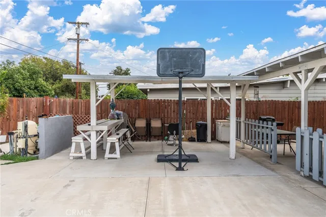 a view of a patio with a table and chairs