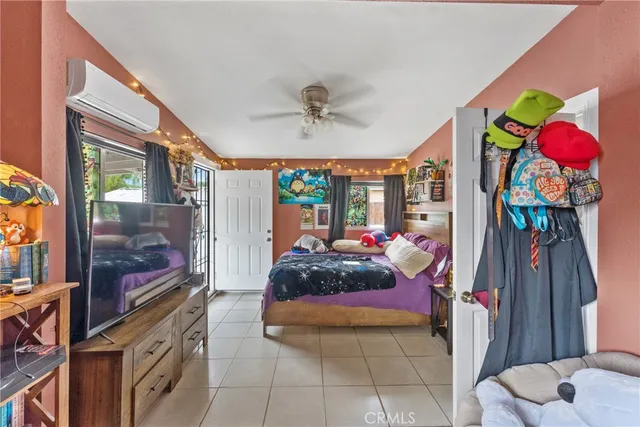 a living room filled with furniture and a flat screen tv