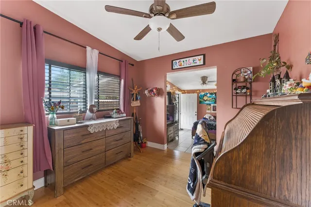 a room with wooden cabinets and ceiling fan